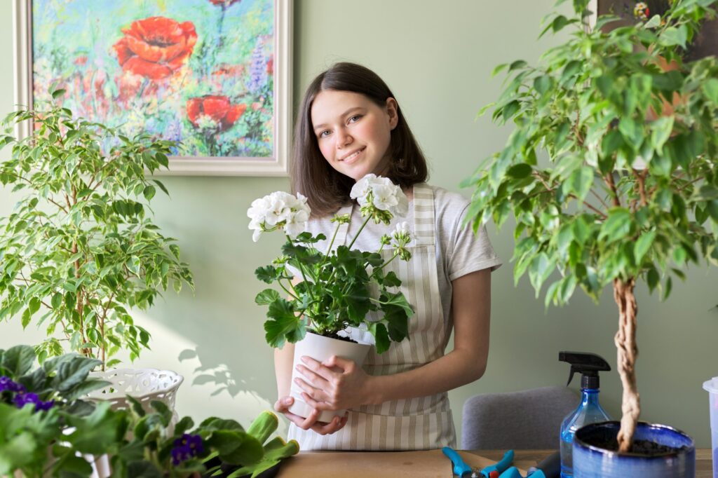 Woman with home plants in pots, hobbies and leisure